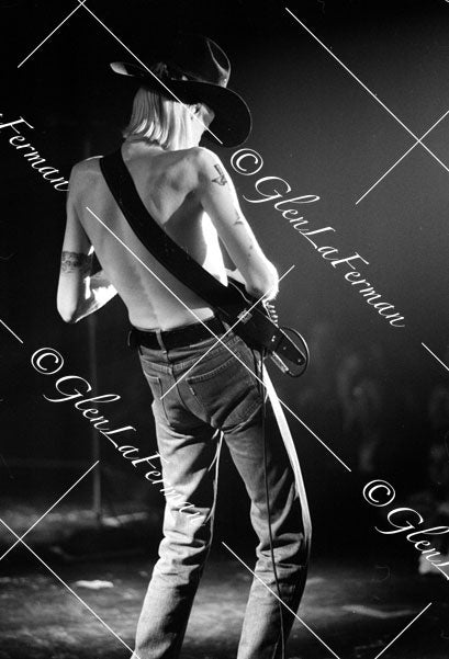Johnny Winter live, facing audience, shirtless