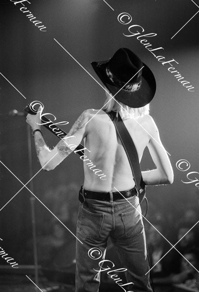 Johnny Winter live facing audience, shirtless