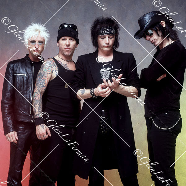 L.A. Guns as a group in black, looking down