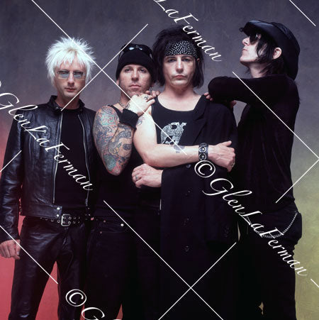 L.A. Guns as a group in black, taking off jacket