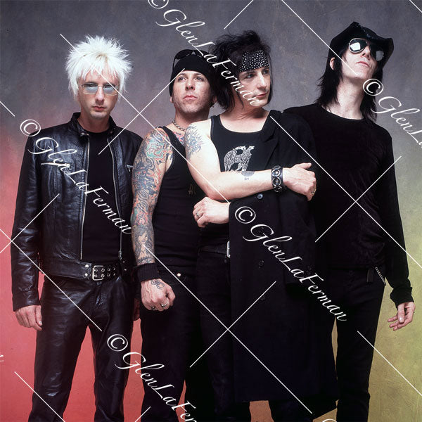 L.A. Guns as a group in black, arm around
