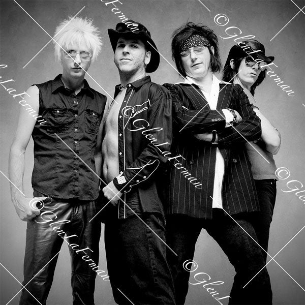 L.A. Guns as a group, open shirt, pinstriped suit
