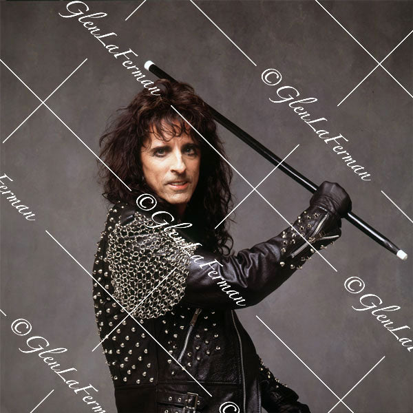 Alice Cooper with leather jacket swinging baton