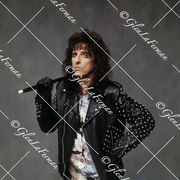 Alice Cooper with leather jacket batting with baton