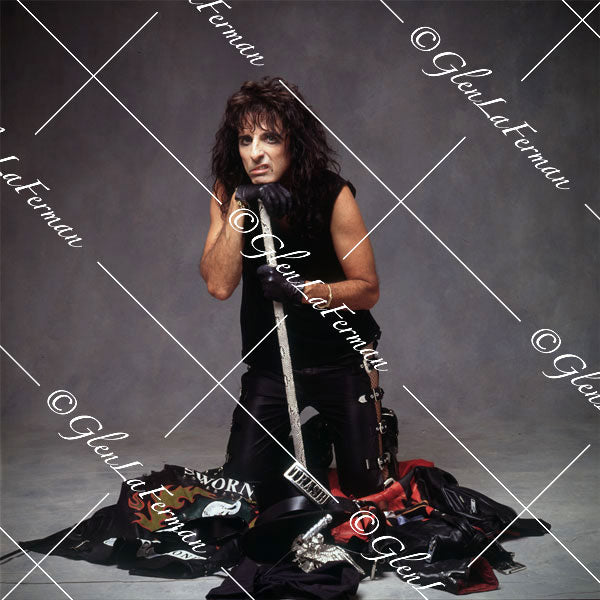 Alice Cooper with sleeveless shirt and props