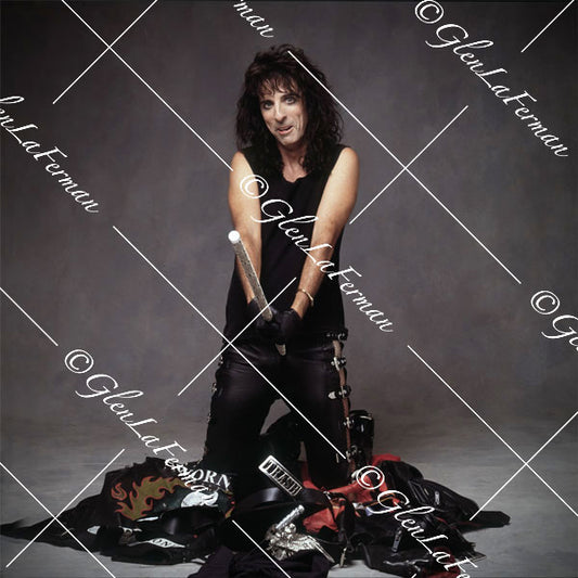 Alice Cooper kneeling with prop