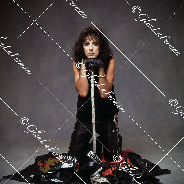 Alice Cooper resting chin on baton