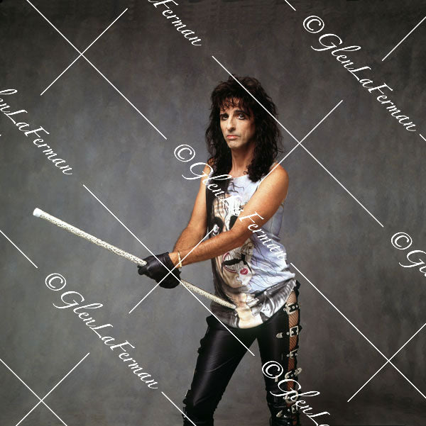 Alice Cooper holding white baton