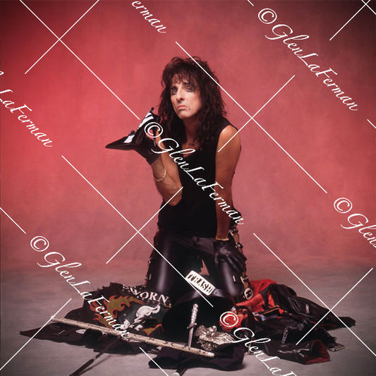 Alice Cooper in sleeveless shirt holding a stiletto