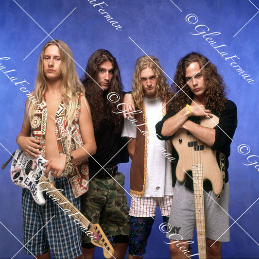 Alice in Chains holding guitars, leaning