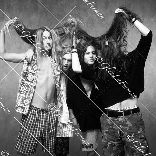 Alice in Chains holding their hair, covering faces