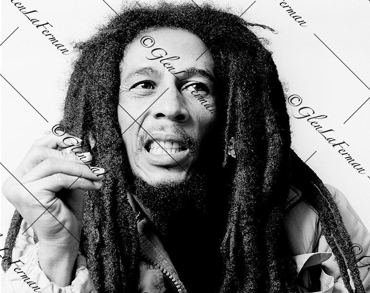 Photograph and Print of Bob Marley gritting teeth, hand up