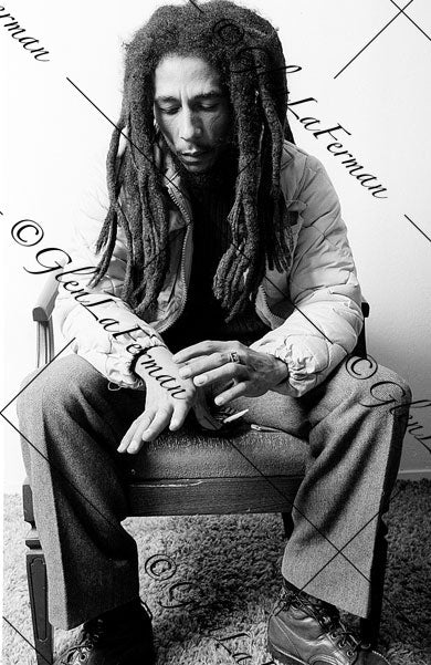 Photograph and Print of Bob Marley pensive, looking at hands