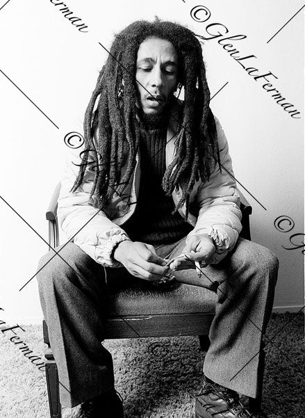 Photograph and Print of Bob Marley smoking, looking at hands