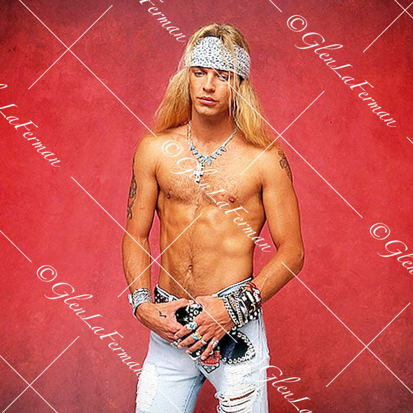 Brett Michaels standing shirtless with red drop