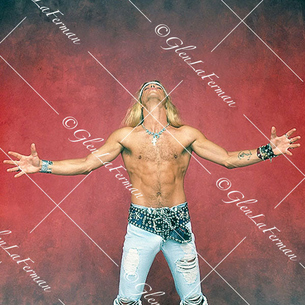 Brett Michaels standing shirtless with arms outstretched