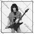Eddie Van Halen in button up standing with guitar