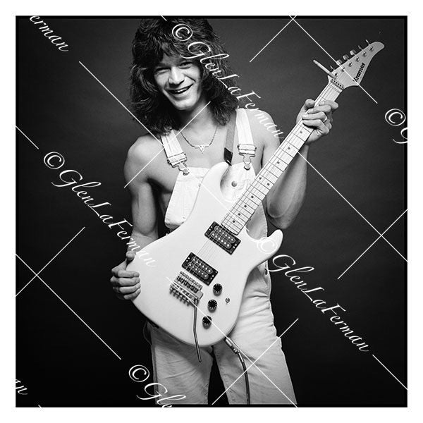 A Photograph and Print of Eddie Van Halen smiling with white guitar in overalls