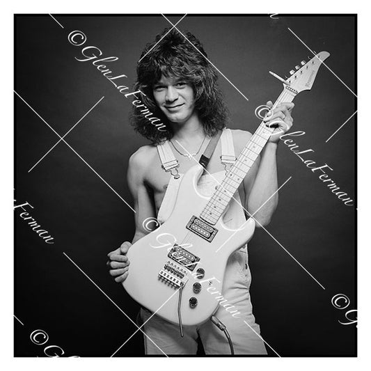 A Print and Photograph of Eddie Van Halen in overalls holding guitar