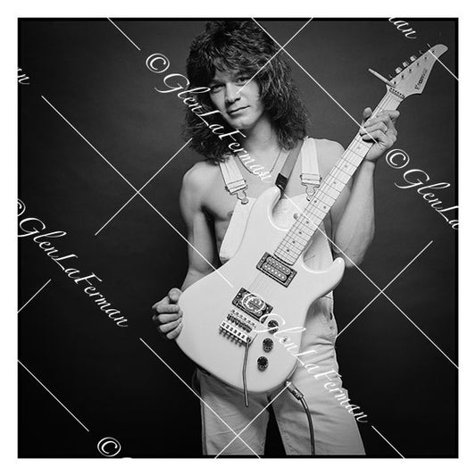 A Print and Photograph of Eddie Van Halen in overalls holding guitar