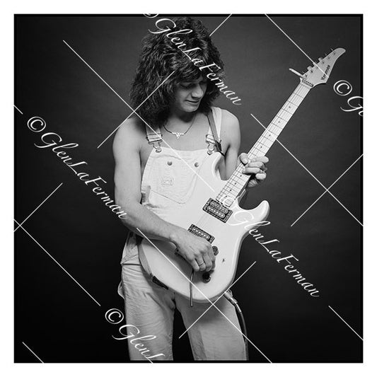 A Print and Photograph of Eddie Van Halen in overalls looking at guitar