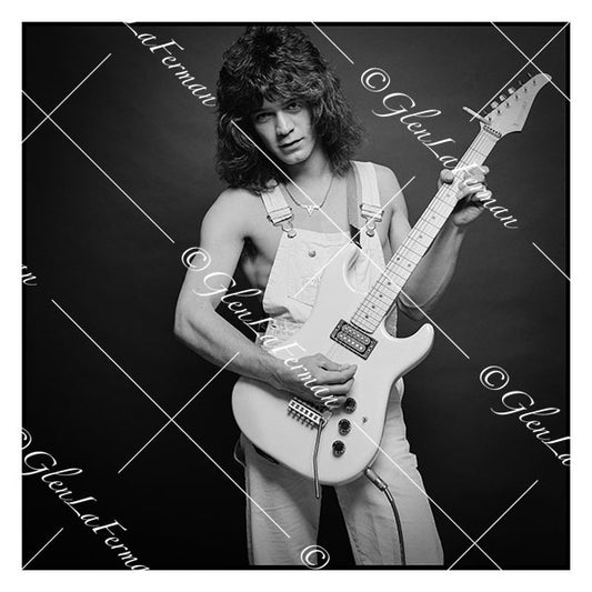 A Print and Photograph of Eddie Van Halen in overalls strumming guitar