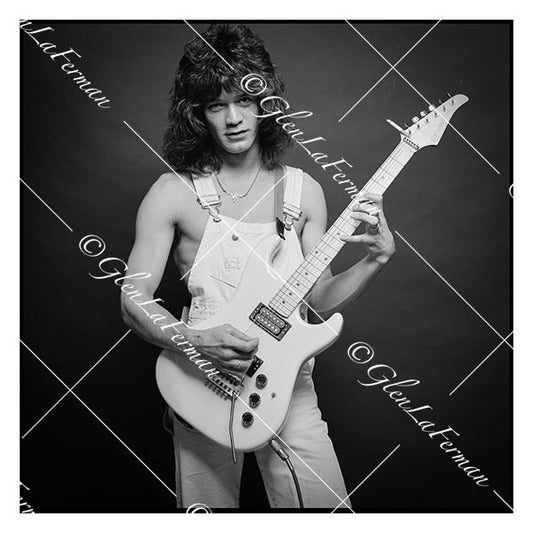 A Print and Photograph of Eddie Van Halen in overalls strumming his guitar