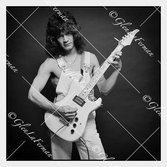 A Print and Photograph of Eddie Van Halen in overalls with guitar