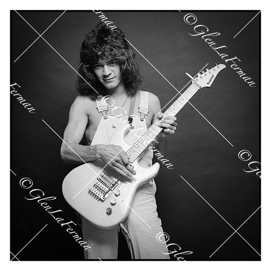 A Print and Photograph of Eddie Van Halen in overalls leaning back with guitar