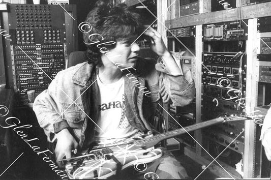 A Print and Photograph of Eddie Van Halen in studio with hand on head