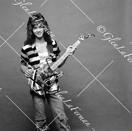 A Print and Photograph of Eddie Van Halen in striped shirt up with Kramer Frankenstrat