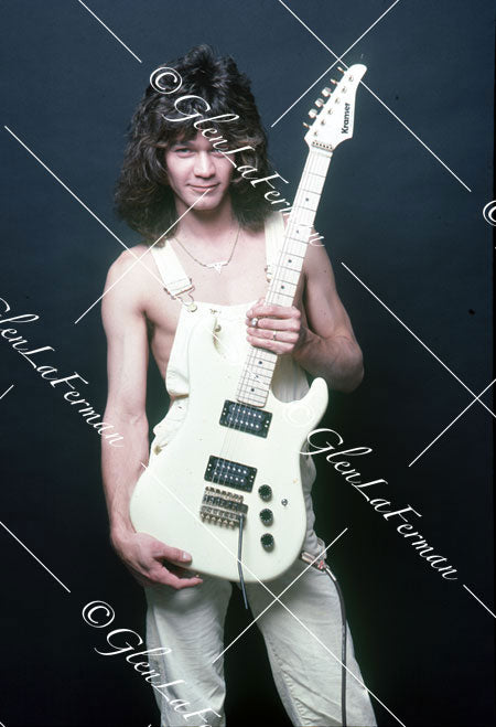 A Print and Photograph of Eddie Van Halen in overalls with white Kramer Frankenstrat