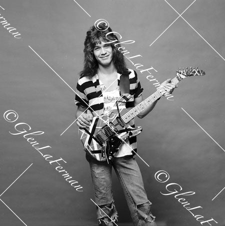 A Print and Photograph of Eddie Van Halen in striped shirt smiling with Kramer Frankenstrat