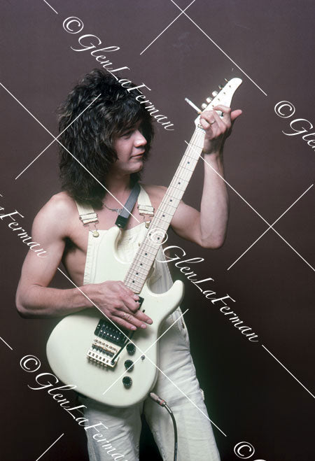 A Print and Photograph of Eddie Van Halen in overalls looking at with Kramer Frankenstrat