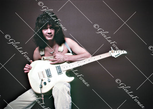 A Print and Photograph of Eddie Van Halen in overalls sitting with Kramer Frankenstrat