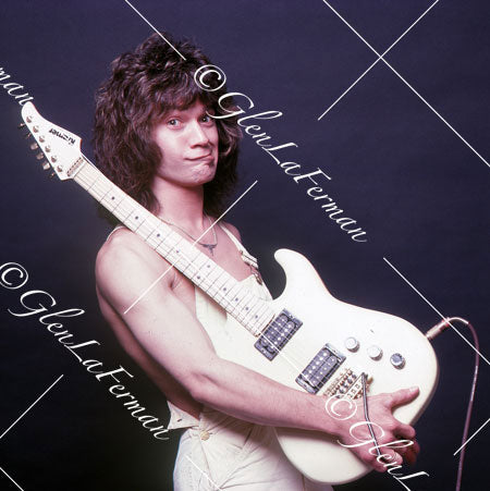 A Print and Photograph of Eddie Van Halen in overalls making a face with Kramer Frankenstrat