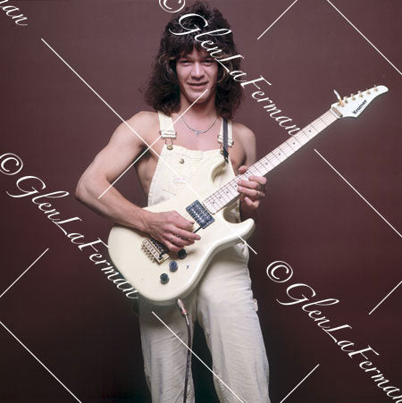 A Print and Photograph of Eddie Van Halen in overalls smiling with Kramer Frankenstrat