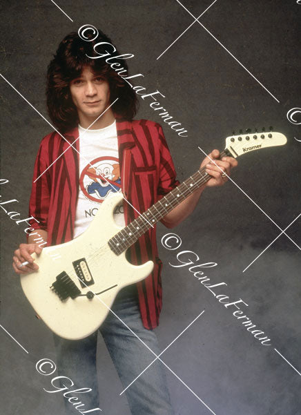 Eddie Van Halen smiling in blazer with cigarette holding Kramer Frankenstrat