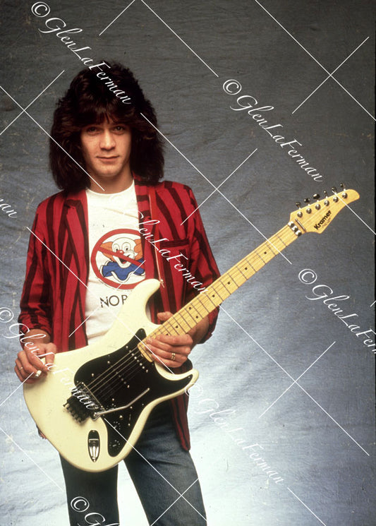 Eddie Van Halen in blazer holding Kramer Frankenstrat