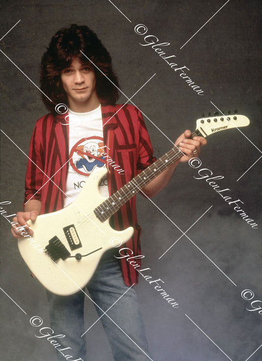 Eddie Van Halen in blazer standing with Kramer Frankenstrat