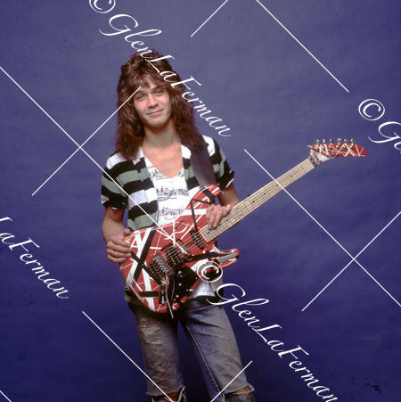 Eddie Van Halen in jeans smiling with Kramer Frankenstrat