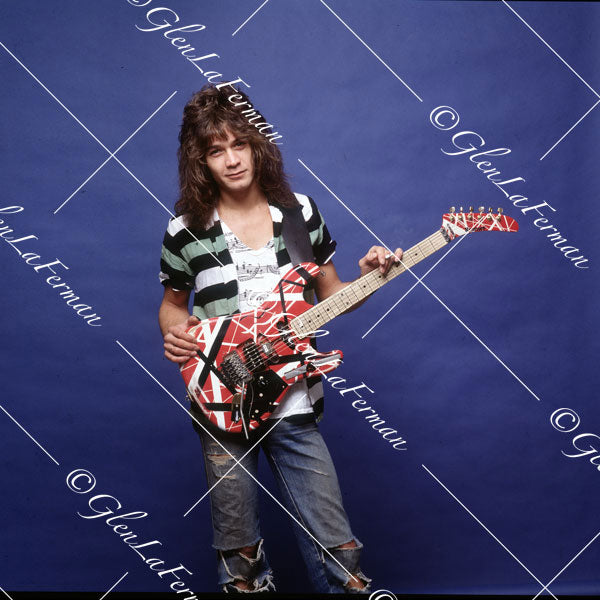 Eddie Van Halen in jeans and Kramer Frankenstrat holding a cigarette