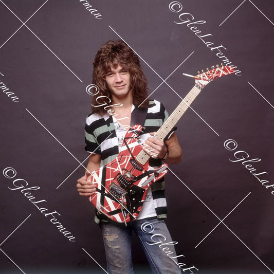 Eddie Van Halen in striped shirt and Kramer Frankenstrat smiling