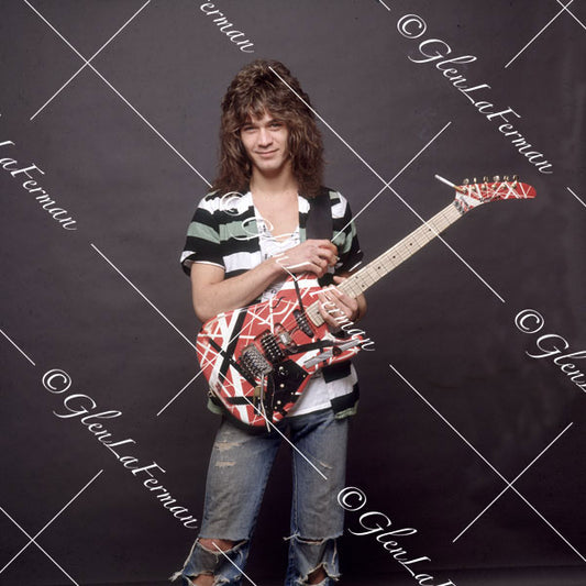 Eddie Van Halen in striped shirt and Kramer Frankenstrat