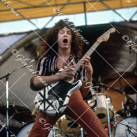 Eddie Van Halen in concert in striped shirt with original Frankenstrat