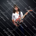 Eddie Van Halen in button up white shirt holding red Frankenstrat