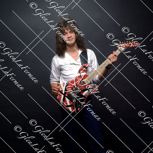 Eddie Van Halen in button up white shirt holding red Frankenstrat