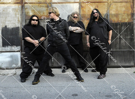 Fear Factory in all black with sunglasses, wide stance