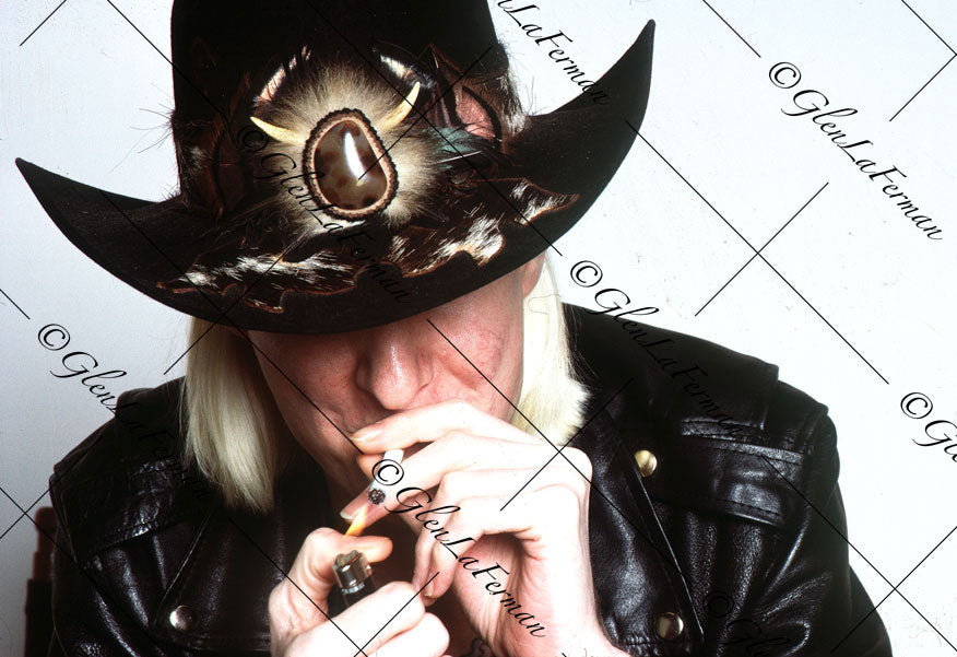 Johnny Winter close up with hat lighting up