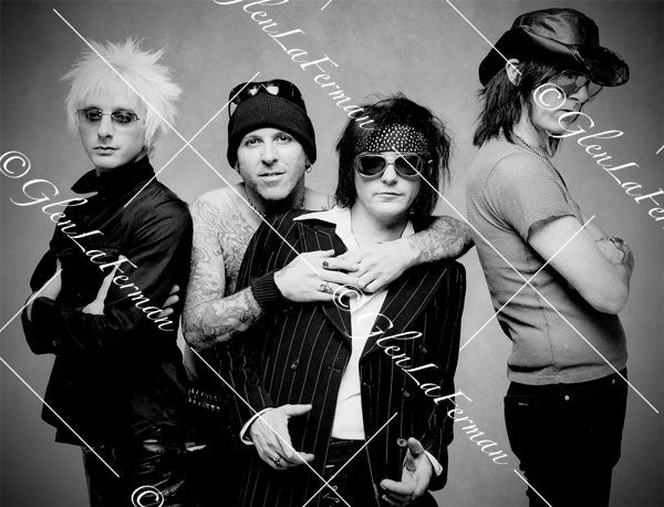 L.A. Guns as a group, pinstriped suit